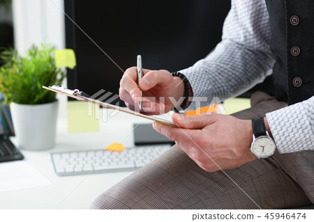 Male arm in suit hold silver pen and pad Male arm in suit hold silver pen and pad 45946474