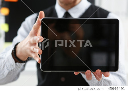 Male arm show tablet pc screen to camera closeup Male arm show tablet pc screen to camera closeup 45946491