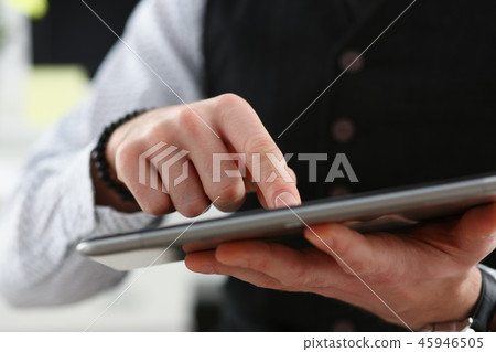 Male arm point finger using tablet pc display Male arm point finger using tablet pc display 45946505