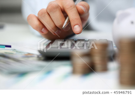 Male hand push key silver calculator is lying Male hand push key silver calculator is lying 45946791