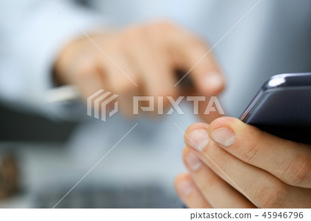 Businessman in the office dials the number Businessman in the office dials the number 45946796