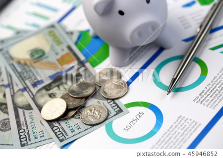 Silver pen lying on desk cash dollar plots Silver pen lying on desk cash dollar plots 45946852