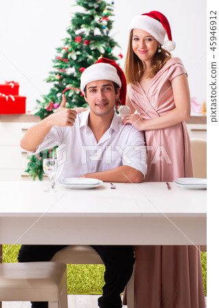 Young couple preparing for christmas meal Young couple preparing for christmas meal 45946912