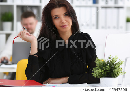 Beautiful smiling brunette woman sit at work table Beautiful smiling brunette woman sit at work table 45947206