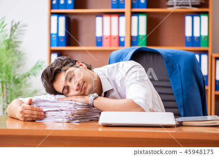 Young employee working in the office Young employee working in the office 45948175