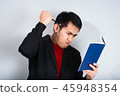 Angry businessman shout with book 45948354