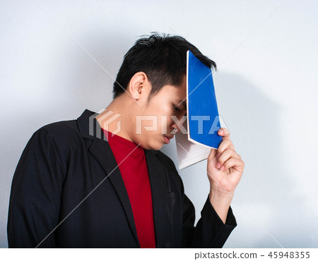 Angry businessman shout with book 45948355