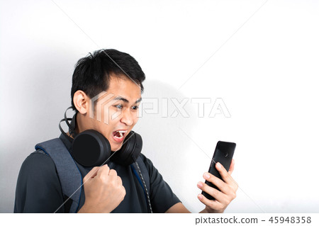 Excited man playing on smartphone 45948358