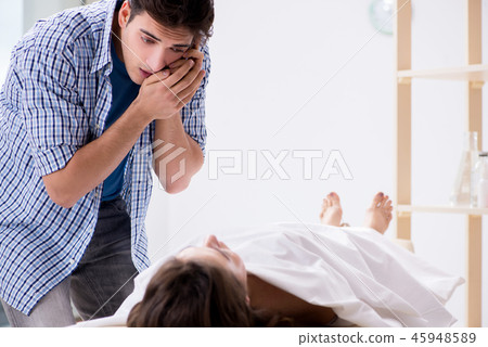 Man mourning his dead wife 45948589