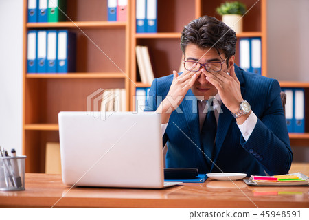 Young handsome businessman working in the office 45948591