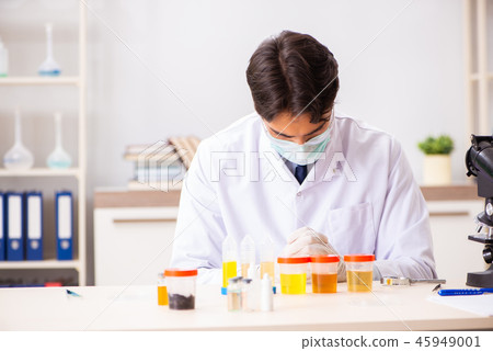 Young handsome chemist working in the lab Young handsome chemist working in the lab 45949001
