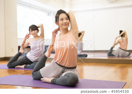 Young Japanese woman doing yoga pose of pigeon Young Japanese woman doing yoga pose of pigeon 45954530