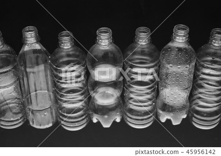 Crushed plastic bottle inside black background 45956142