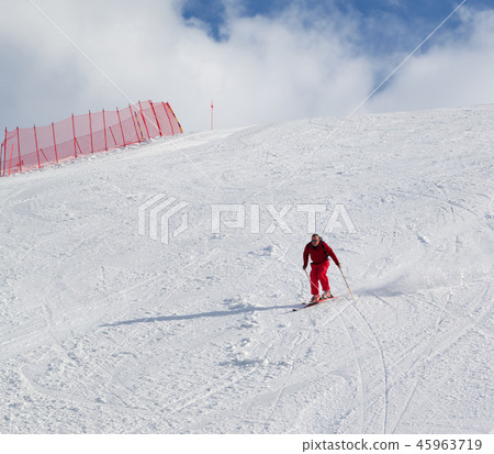 Skier descend on snow sunlight ski slope at winter 45963719