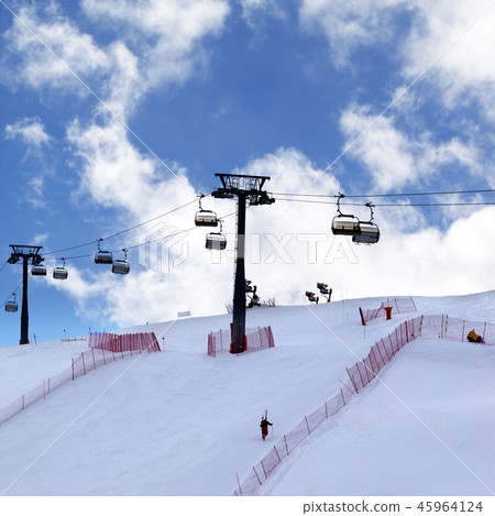 Skier ascend on snow ski slope and ski-lift  45964124