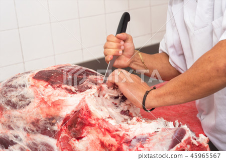 butcher cutting meat in the butchery. Close up 45965567