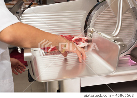 butcher cutting meat in the butchery. Close up 45965568