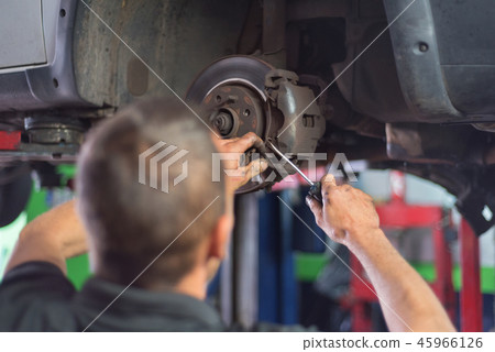 Close up of car mechanic repairing brake pads 45966126