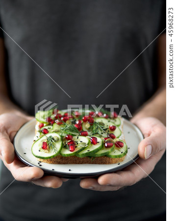 Vegan sandwich with cucmber in male hands Vegan sandwich with cucmber in male hands 45968273