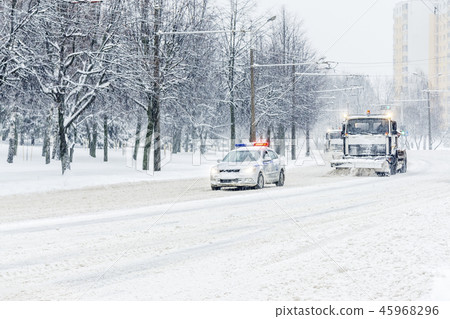 Snow plow truck convoy with patrol police car 45968296