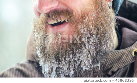 Smiling young man with beard in icicles 45968356