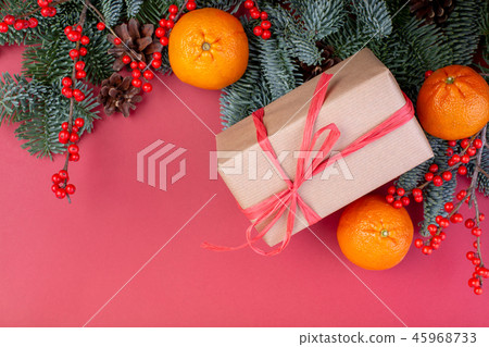 Christmas composition. Christmas red decorations, fir tree branches with toys gift boxes on red 45968733