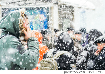 People on bus stop in snowfall 45968796