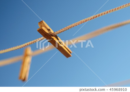 Clothespins on a clothesline against a blue sky Clothespins on a clothesline against a blue sky 45968910