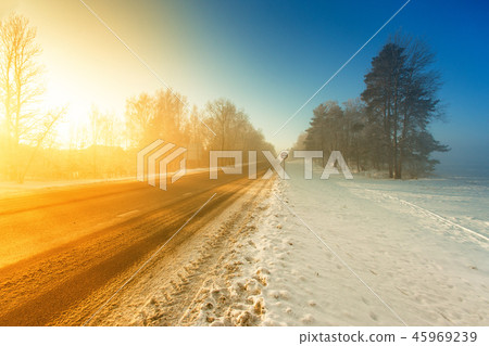 Winter misty highway road in morning sunlight 45969239