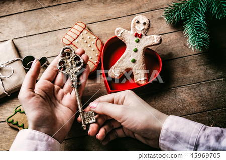hands holding cgilden christmas key  45969705