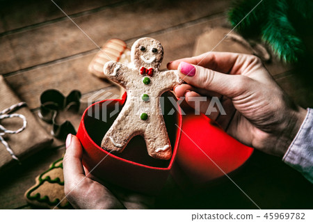 hands holding christmas gingerbread man 45969782