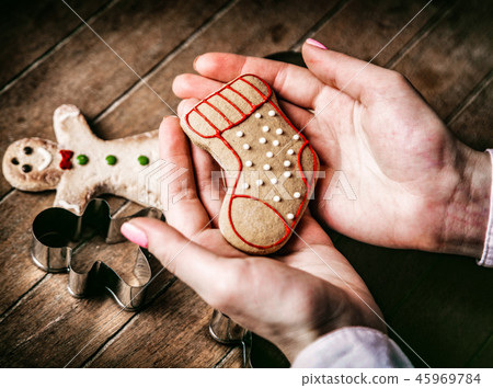 hands holding gingerbread cookie hands holding gingerbread cookie 45969784