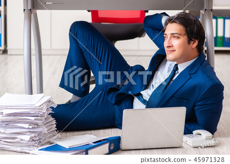 Tired exhausted businessman working overtime in office Tired exhausted businessman working overtime in office 45971328