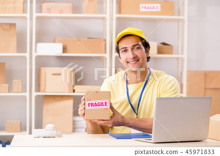 Handsome contractor working in box delivery relocation service Handsome contractor working in box delivery relocation service 45971833