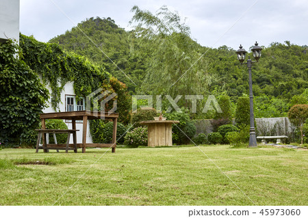 Chair and table decoration in garden Chair and table decoration in garden 45973060