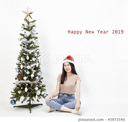 Young girl decorating Christmas tree. 45973540