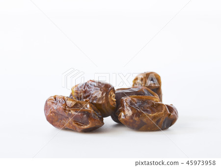 Dried halawi dates on a white 45973958