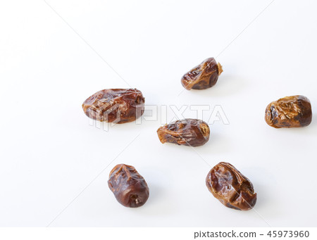 Dried halawi dates on a white Dried halawi dates on a white 45973960