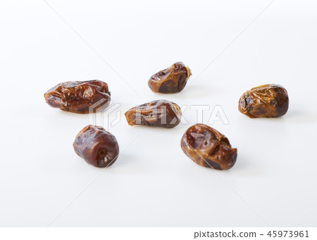 Dried halawi dates on a white 45973961