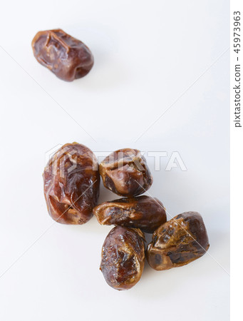 Dried halawi dates on a white Dried halawi dates on a white 45973963