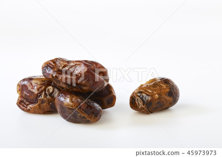 Dried halawi dates on a white Dried halawi dates on a white 45973973
