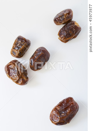 Dried halawi dates on a white 45973977