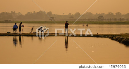 Catching fish on lake at sunrise 45974033