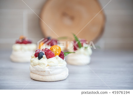 Pavlova meringue cake with cream and small fruits 45976194