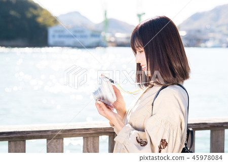 Women's Journey Onomichi instant camera at the seaside 45978084