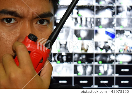 man and radio communicationblurred cctv monitor 45978160