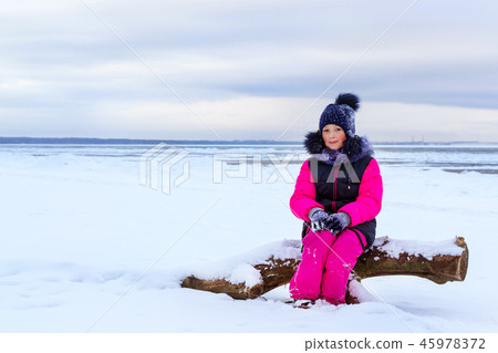 Teenage girl walking on sea shore Narva Estonia Teenage girl walking on sea shore Narva Estonia 45978372