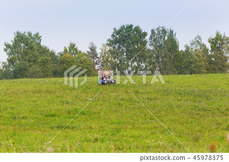 Elegant woman riding quadrocycle on spring field Elegant woman riding quadrocycle on spring field 45978375