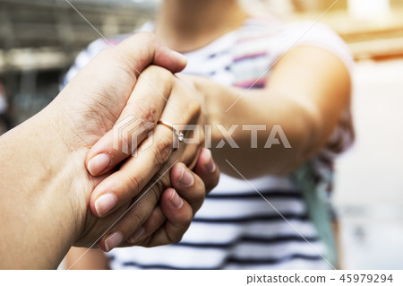 Beautiful women handshake with boyfriend close up. Beautiful women handshake with boyfriend close up. 45979294