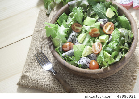 Fresh salad with avocado in wooden bowl. Healthy Fresh salad with avocado in wooden bowl. Healthy 45980921